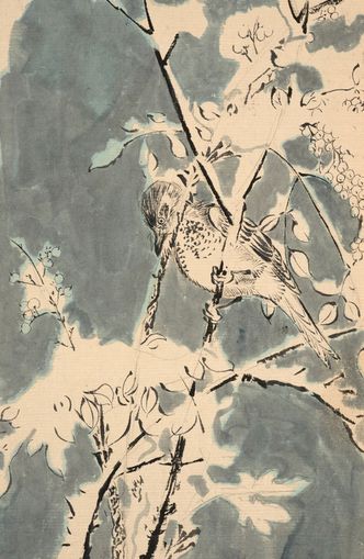 Quiet bird in berry branches