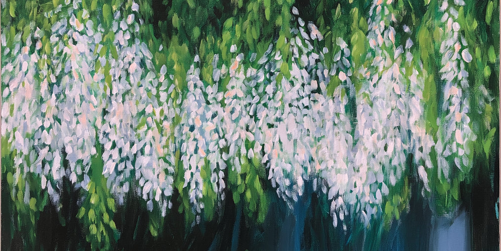 Pale blossoms in green shade
